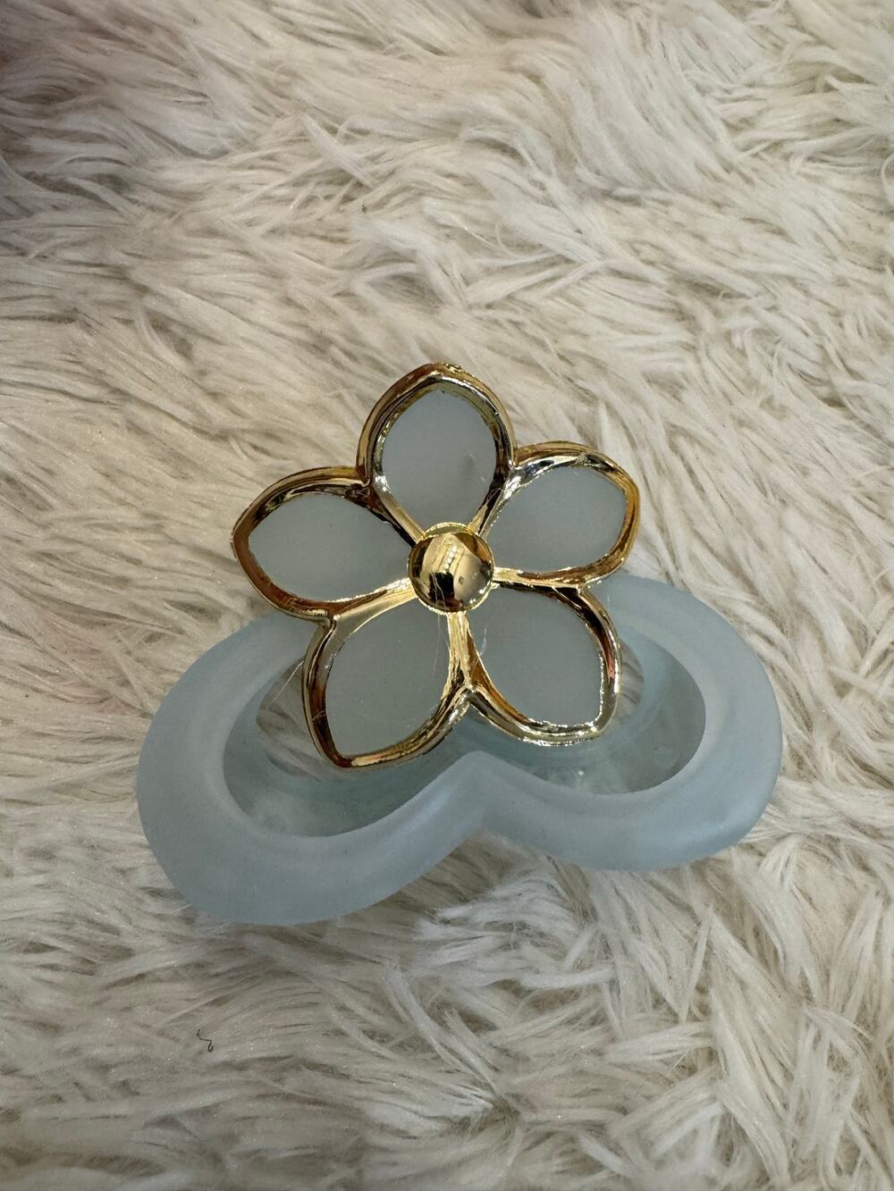 Blue & gold flower hair clip with gold flower-shaped frame and light blue petals